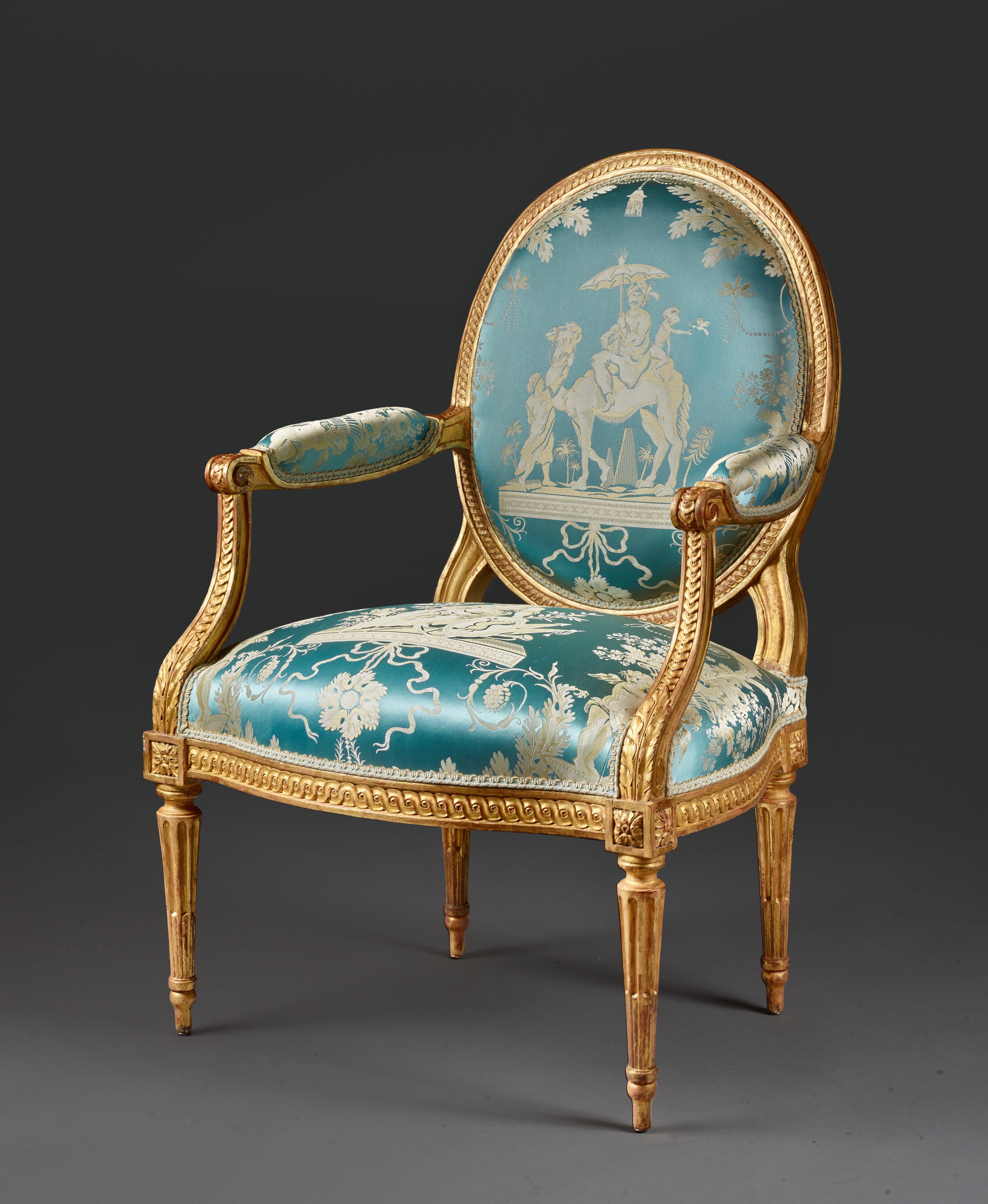A pair of carved and gilt wood armchairs