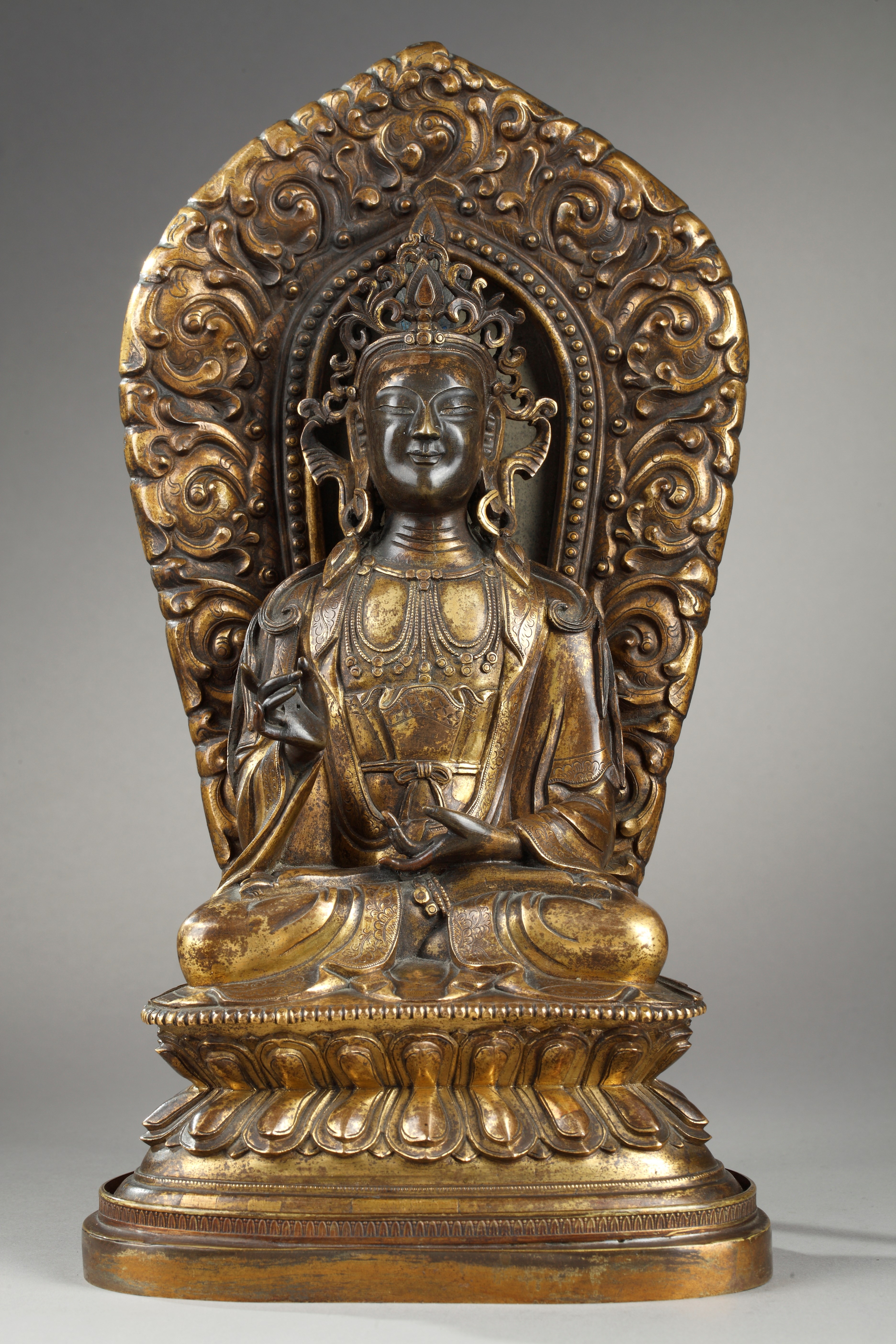 A gilt-bronze figure of a bodhisattva with a mandorla